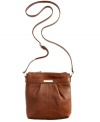 Simple and seriously chic, this versatile crossbody from Calvin Klein adds just the right amount of polish to your everyday attire. The sleek shape, neutral hue and refined detailing make it the obvious choice in exquisite accessorizing.