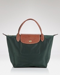 Longchamp's signature day bag is sized down for lesser loads. Crafted from durable nylon and proportioned for handheld ease, it's a small scale way to work the brand's effortless chic. Longchamp's signature day bag is sized down for lesser loads. Crafted from durable nylon and proportioned for handheld ease, it's a small scale way to work the brand's effortless chic.