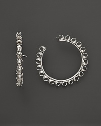 Bold sterling silver hoop earrings showcase Di MODOLO's unique Triadra cages. Bold sterling silver hoop earrings showcase Di MODOLO's unique Triadra cages.
