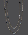 Round checkerboard blue topaz stations gleam on a long, loopable 14K yellow gold chain.
