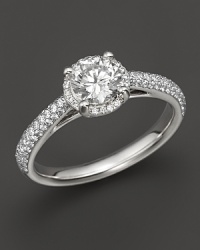 Win her heart with this stunning engagement ring. White gold band with diamond pavé stones and a brilliant round center diamond. Win her heart with this stunning engagement ring. White gold band with diamond pavé stones and a brilliant round center diamond.