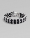 Architectural drama defines this bold bracelet, constructed of double rows of black onyx beads held by scalloped pillars of sterling silver. Black onyx Sterling silver Length, about 8¾ Lobster clasp Imported