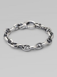 Bold oval links of polished sterling silver have not-so-sinister curved spikes in their centers.Sterling silver Length, about 8½ Lobster clasp Imported