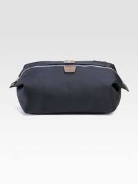 A convenient travel bag in dobby-woven nylon, trimmed with leather and backed with polyurethane for durability and water-resistance. Zip closure Die-cast hardware Interior zip pocket Cotton lining 9¾W X 5½H X 5¼D Imported A convenient travel bag in dobby-woven nylon, trimmed with leather and backed with polyurethane for durability and water-resistance. Zip closure Die-cast hardware Interior zip pocket Cotton lining 9¾W X 5½H X 5¼D Imported