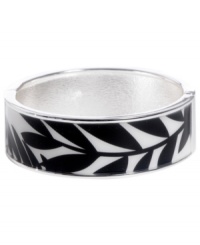 Channel the exoticism and energy of Brasil in Haskell's inspired skinny bangle. The Palm bangle features a black and white palm leaf print design, set in silver tone mixed metal with a hinge clasp. Approximate diameter: 2-1/2 inches. Approximate length: 8 inches. Item comes packaged in a turquoise gift box.