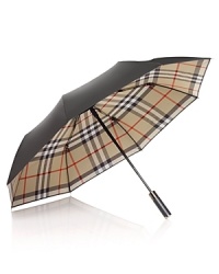 Shield yourself from inclement weather with an iconic umbrella from Burberry.