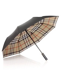 Shield yourself from inclement weather with an iconic umbrella from Burberry. Shield yourself from inclement weather with an iconic umbrella from Burberry.