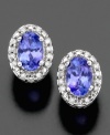 These 14k white gold earrings feature angelic oval-cut tanzanite (3/4 ct. t.w.) surrounded by round-cut diamond accents (1/10 ct. t.w.) for an illuminating effect.
