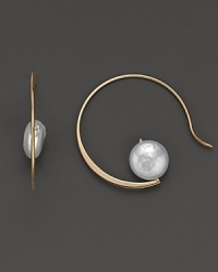 Elegantly shaped 14K yellow gold hoops cradle gleaming cultured coin pearls. Elegantly shaped 14K yellow gold hoops cradle gleaming cultured coin pearls.