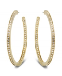 Star-studded style. This elegant pair of gold tone hoop earrings sparkles in clear Swarovski crystal pavé, reflecting the light beautifully and adding a touch of sophistication to any outfit. Approximate diameter: 1-7/8 inches. Star-studded style. This elegant pair of gold tone hoop earrings sparkles in clear Swarovski crystal pavé, reflecting the light beautifully and adding a touch of sophistication to any outfit. Approximate diameter: 1-7/8 inches.