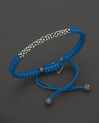 A hand braided cord bracelet in a saturated hue is adorned with Lagos' signature Caviar™ beads and finished with an adjustable closure. A hand braided cord bracelet in a saturated hue is adorned with Lagos' signature Caviar™ beads and finished with an adjustable closure.