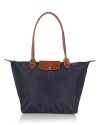 Longchamp's signature nylon tote in a large size lends sophisticated chic to every look, from city jaunts to weekend getaways. Folds up for ease during travel.