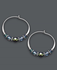 Multi-faceted style. Jody Coyote's unique hoop earrings get an updated look with the addition of faceted blue glass beads, seed beads, sterling silver beads and antique silver plated pewter beads. Set in sterling silver. Approximate diameter: 7/8 inch. Multi-faceted style. Jody Coyote's unique hoop earrings get an updated look with the addition of faceted blue glass beads, seed beads, sterling silver beads and antique silver plated pewter beads. Set in sterling silver. Approximate diameter: 7/8 inch.