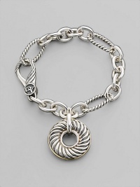 A doughnut-shaped cabled charm on a bold sterling silver chain of smooth and textured links, with accents of 18k gold. Sterling silver and 18k yellow gold Bracelet length, about 7½ Charm diameter, about 1 Spring clip clasp Made in USA A doughnut-shaped cabled charm on a bold sterling silver chain of smooth and textured links, with accents of 18k gold. Sterling silver and 18k yellow gold Bracelet length, about 7½ Charm diameter, about 1 Spring clip clasp Made in USA