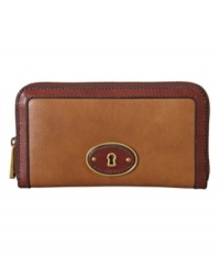 A sophisticated take on a vintage-chic design. This polished look by Fossil features a signature lock detailed front and an easy zip around closure for a refined appeal. A sophisticated take on a vintage-chic design. This polished look by Fossil features a signature lock detailed front and an easy zip around closure for a refined appeal.