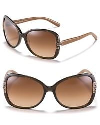 Tory Burch adds her signature look to these oversized sunglasses with metal T detail at temples. Tory Burch adds her signature look to these oversized sunglasses with metal T detail at temples.