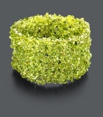 Go green in a whole new way with this organic cuff. Bracelet features bright green peridot chips (4-6 mm) and stretches to fit the wrist. Approximate length: 4 inches.