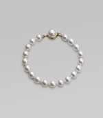 A single strand of round white pearls is an eternally elegant essential. 8mm white organic man-made pearls Length, about 7 18k goldplated sterling silver mabé pearl push-lock clasp Made in Spain