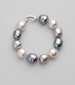 A stunning bracelet of baroque pearls in a palette of whisper soft pastels. 14mm white, grey and nuage man-made organic pearls Length, about 8 Rhodium-plated sterling silver spring clip clasp Made in Spain