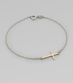 A simple, sleek cross of 14k gold sits sideways within a delicate sterling silver chain in this eloquent design.14k yellow gold and sterling silverLength, about 7Spring ring claspMade in USA