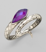 From the Queen Cobra Collection. A sensuous snake with textured scales of sterling silver and a faceted head of purple sugalite coils its way alluringly around the wrist. Purple sugalite and hematite Sterling silver Diameter, about 2½ Width, about 1¾ Imported