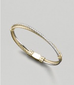 From the Crossover Collection. A slender cable of 18k gold crisscrosses a band of sparkling pavé diamonds in an elegantly understated bangle. Diamonds, 0.57 tcw 18k yellow gold Diameter, about 2½ Made in USA
