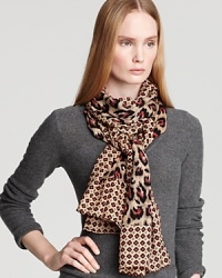Tie on the trend in Tory Burch's eye-catching animal-print scarf, mixed with a geometric border and unexpected hues. Tie on the trend in Tory Burch's eye-catching animal-print scarf, mixed with a geometric border and unexpected hues.