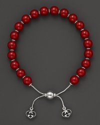 Varnished red wooden beads on a sterling silver bracelet from Gucci. Varnished red wooden beads on a sterling silver bracelet from Gucci.