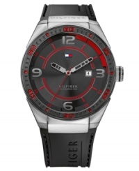 Bold color gives this casual watch from Tommy Hilfiger a modern air. Crafted of black silicone strap and round stainless steel case with logo. Black bezel features red numerals and stick markers. Black dial features silver tone numerals at three, six, nine and twelve o'clock, tachymeter scale, red inner minute track and stick markers, cut-out silver tone hour and minute hands, red second hand, date window at three o'clock and iconic flag logo at twelve o'clock. Quartz movement. Water resistant to 50 meters. Ten-year limited warranty. Bold color gives this casual watch from Tommy Hilfiger a modern air. Crafted of black silicone strap and round stainless steel case with logo. Black bezel features red numerals and stick markers. Black dial features silver tone numerals at three, six, nine and twelve o'clock, tachymeter scale, red inner minute track and stick markers, cut-out silver tone hour and minute hands, red second hand, date window at three o'clock and iconic flag logo at twelve o'clock. Quartz movement. Water resistant to 50 meters. Ten-year limited warranty.