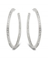 Stellar style fit for a celebrity. This elegant pair of silver tone mixed metal hoop earrings sparkles in clear Swarovski crystal pavé and reflects the light in a thousand facets. These unique earrings add a touch of sophistication to your look. Approximate diameter: 1-7/8 inches.