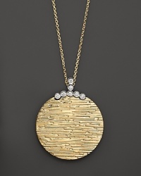 Diamonds add glamor to a beautifully textured 18K yellow gold disk on a 18K white gold chain. By Roberto Coin. Diamonds add glamor to a beautifully textured 18K yellow gold disk on a 18K white gold chain. By Roberto Coin.