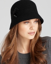 Clustered jewels and a ribbon bow give this classic cloche from August Accessories ladylike appeal. Clustered jewels and a ribbon bow give this classic cloche from August Accessories ladylike appeal.