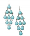 A splash of summer. Fossil's vibrant chandelier earrings boast turquoise-colored resin stones set in silver tone mixed metal. Approximate drop: 3-1/4 inches.