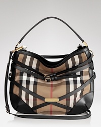 Belted details add equestrian charm to this Burberry hobo, iconic in the brand's signature check print. Belted details add equestrian charm to this Burberry hobo, iconic in the brand's signature check print.
