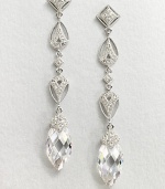 This refined piece features a long drop consisting of various shapes accented in pavé crystals, culminating in a faceted cubic zirconia stone. CrystalsCubic zirconiaRhodium-plated brassLength, about 2.5Post backImported 