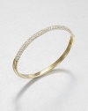 From the Brilliance Collection. Half of this graceful bangle is paved with sparkling rhinestones, the other half has a smooth, polished finish, with a handy hinge in between.GlassGoldtoneDiameter, about 2.5Hinged with push-lock claspImported