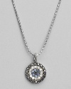 Rings of mysterious black diamonds, sparkling white diamonds and cool blue sapphires make a glamorous pendant set in 14k white gold. Diamonds, 0.26 tcw Sapphires 14k white gold Chain length, about 16 Medallion diameter, about ½ Lobster clasp Imported