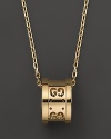 Gucci's iconic Gs circle a gleaming pendant of 18K yellow gold.