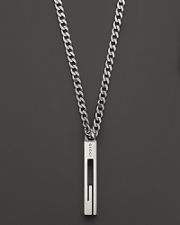 A sterling silver chain bears a Gucci logo pendant. A sterling silver chain bears a Gucci logo pendant.