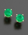 Burst onto the scene with eye-catching green. Stud earrings feature vibrant, round-cut emeralds (1 ct. t.w.) in a 14k gold post setting. Approximate diameter: 5 mm.