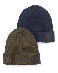 Solid ribbed beanie crafted in a cozy cotton/wool blend, with leather logo patch. Solid ribbed beanie crafted in a cozy cotton/wool blend, with leather logo patch.