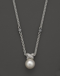 A cultured freshwater pearl is detailed in sparkling diamonds, strung on a sterling silver chain on Lagos' Luna necklace. A cultured freshwater pearl is detailed in sparkling diamonds, strung on a sterling silver chain on Lagos' Luna necklace.