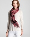 Bundle up in Burberry's soft cashmere scarf with signature giant check print in dusty pink and gray.