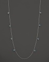 Inspired by Zen philosophy, this intricately detailed sterling silver necklace from Paul Morelli softly jingles with eight meditation bells and cabochons of blue topaz.