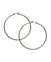 Snap up effortless style in simple hoops. GUESS earrings feature a polished, large hoop design in gold tone mixed metal. Approximate diameter: 1-1/2 inches. Snap up effortless style in simple hoops. GUESS earrings feature a polished, large hoop design in gold tone mixed metal. Approximate diameter: 1-1/2 inches.