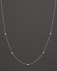 A white gold chain with five bezel-set diamond stations. A white gold chain with five bezel-set diamond stations.