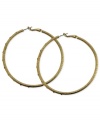 A stylish must-have. These clutchless hoop earrings from GUESS feature a diamond dust design with glass stones. Crafted in gold tone mixed metal. Approximate diameter: 2-1/2 inches.