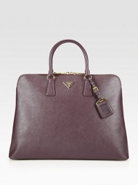 Roomy carryall with a structured frame in saffiano lux leather.Double top handles, 4¾ dropTop zip closureProtective metal feetOne inside zip compartmentOne inside zip pocketThree inside open pocketsSignature jacquard lining16W X 11¾H X 6DMade in Italy Roomy carryall with a structured frame in saffiano lux leather.Double top handles, 4¾ dropTop zip closureProtective metal feetOne inside zip compartmentOne inside zip pocketThree inside open pocketsSignature jacquard lining16W X 11¾H X 6DMade in Italy