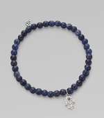 The hamsa, a traditional protective amulet, is encrusted with diamonds and accented with one sapphire as it hangs from a stretchy strand of deep-toned sodalite beads. Diamonds, 0.05 tcw Sodalite 14k white gold Diameter, about 2 (unstretched) Charm length, about ½ Imported