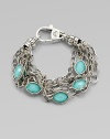 Stations of bright, faceted, crystal accented turquoise stone set in sterling silver on detailed link chains. Crystal accented turquoise doubletsSterling silverLength, about 7Lobster clasp closureImported